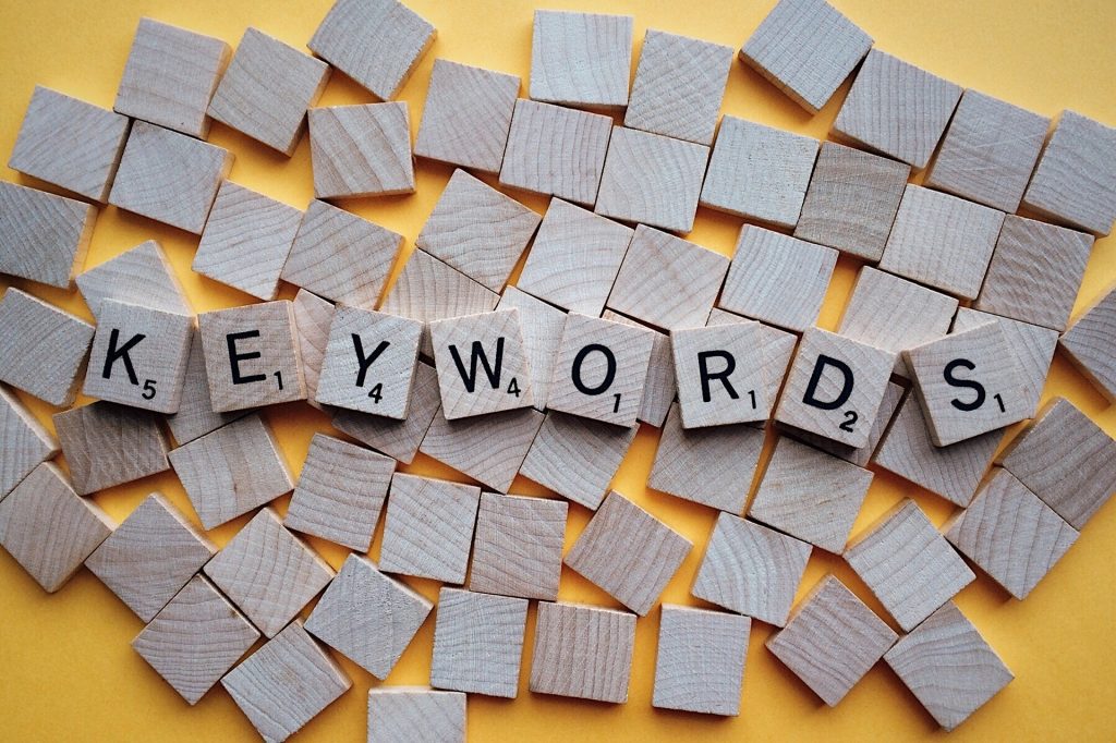 scrabble-like tiles with some turned up to spell out the word 'Keywords' for SEO